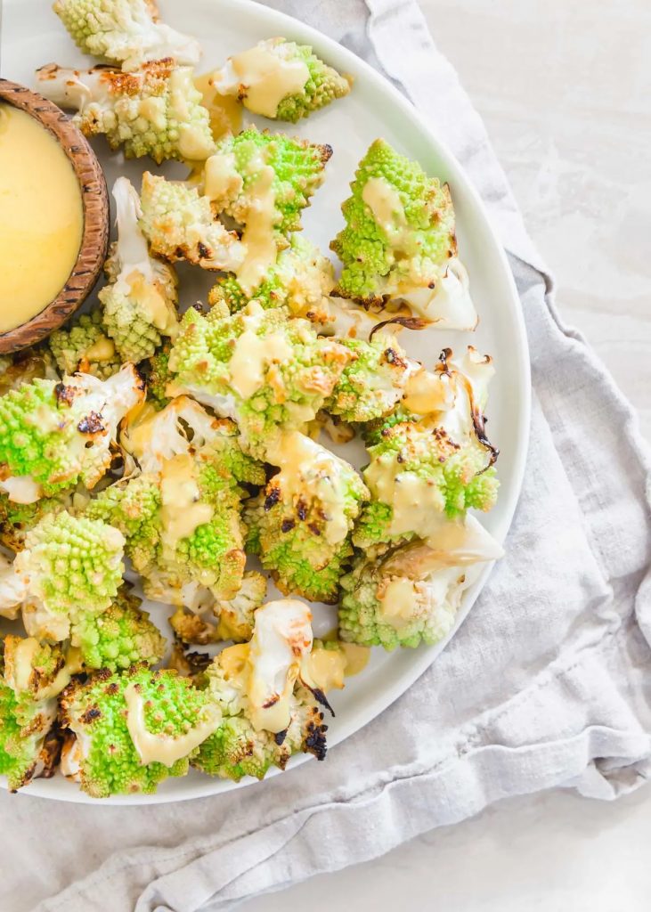 Photo of Roasted Romanesco being served with Tahini sauce.