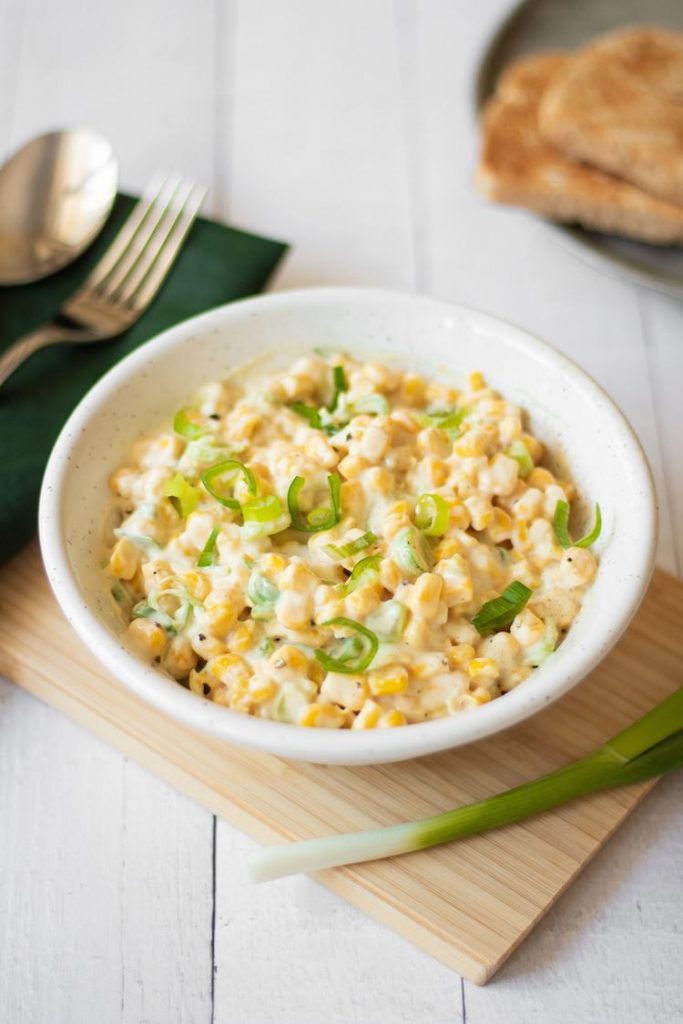 Photo of a small white bowl serving Creamy Vegan Corn Salad.