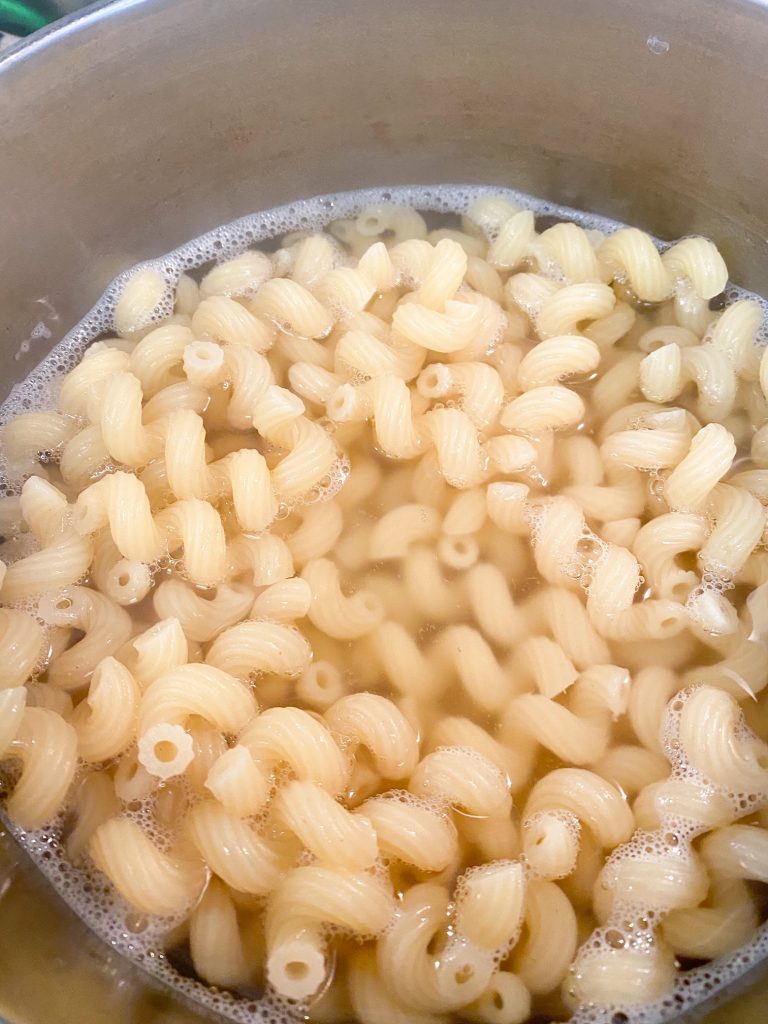 Spiraled pasta being boiled in water