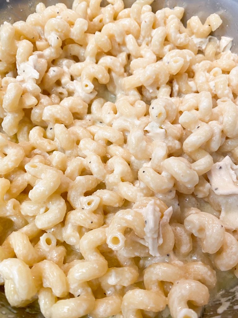 close up of brie mac and cheese recipe with small bits of pepper in it.