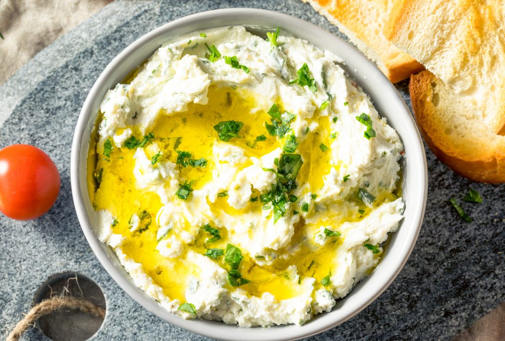 herb goat cheese dip from above with tomatoes and bread