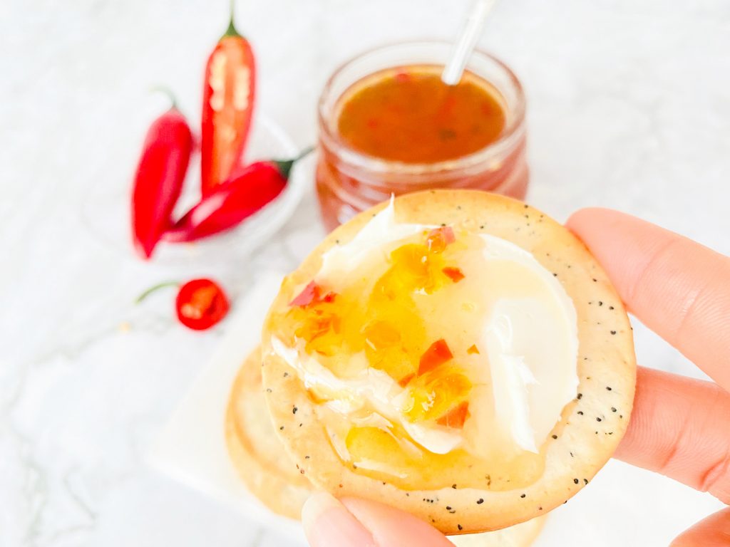 jalapeno jelly spread over cream cheese on crackers