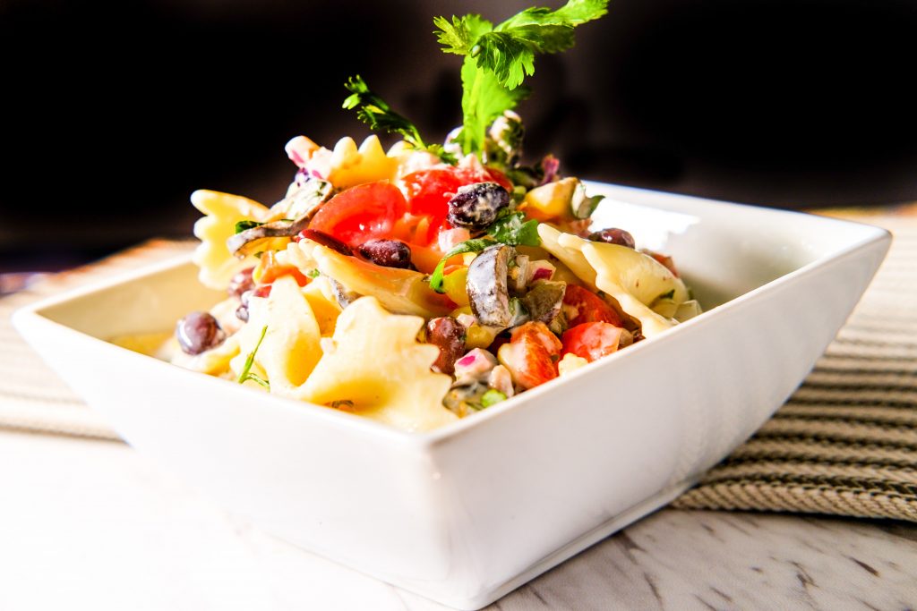 mexican street corn pasta salad against a black background