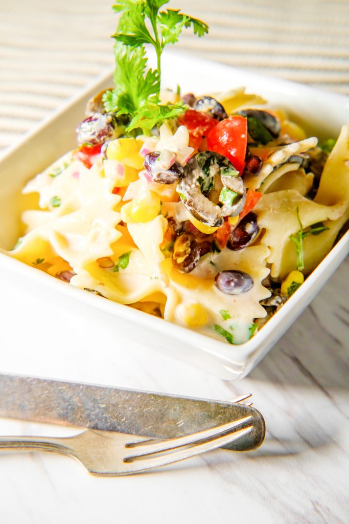 Mexican street corn pasta salad in a bowl with utensils