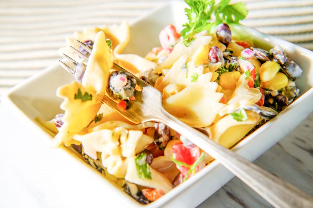 bowl of mexican street corn pasta salad with a fork