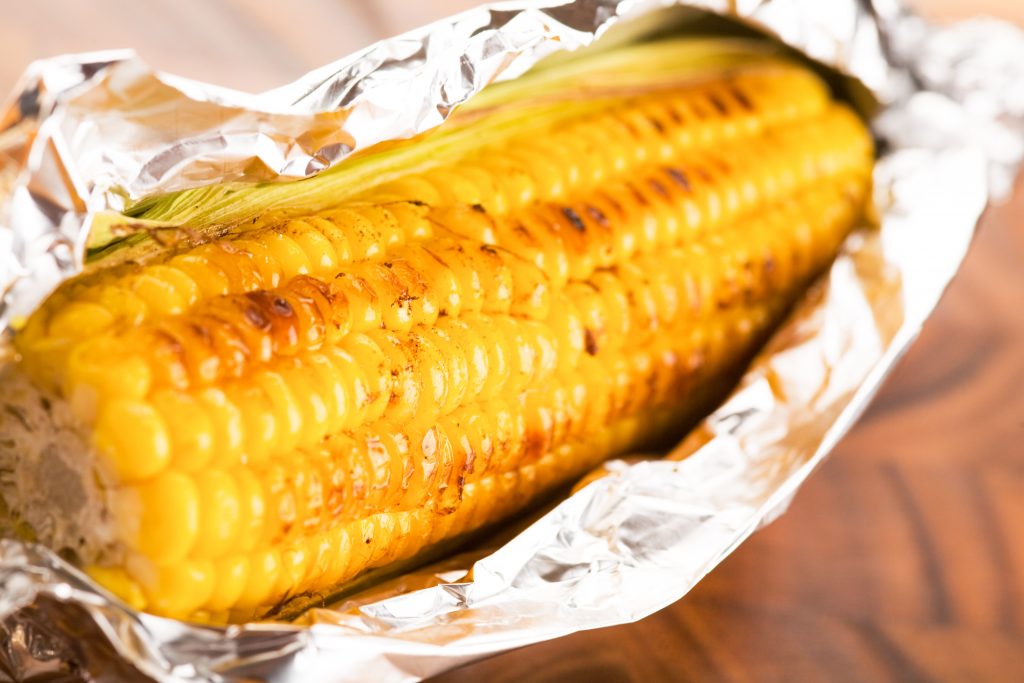 corn wrapped in tin foil for roasting