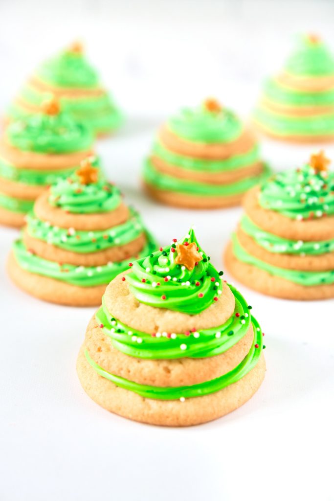 above angle of stacked sugar cookie Christmas trees on a white counter