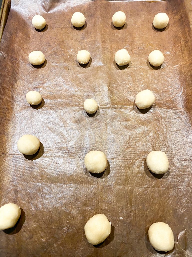 balls of sugar cookie dough on a tray