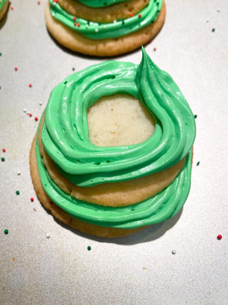 green icing on top of cookies for making stacked sugar cookie christmas trees