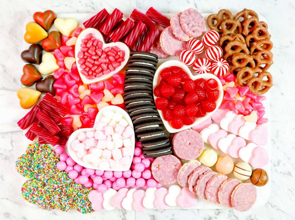 overview of valentines day charcuterie board with cookies and candy