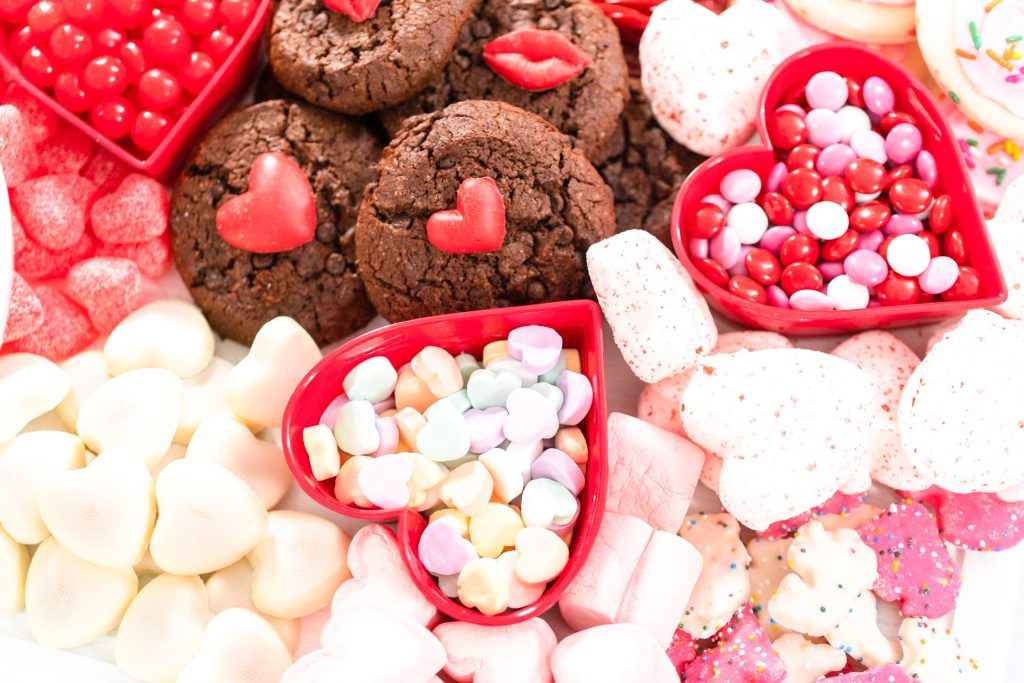 close up of cookies and candies on a dessert board