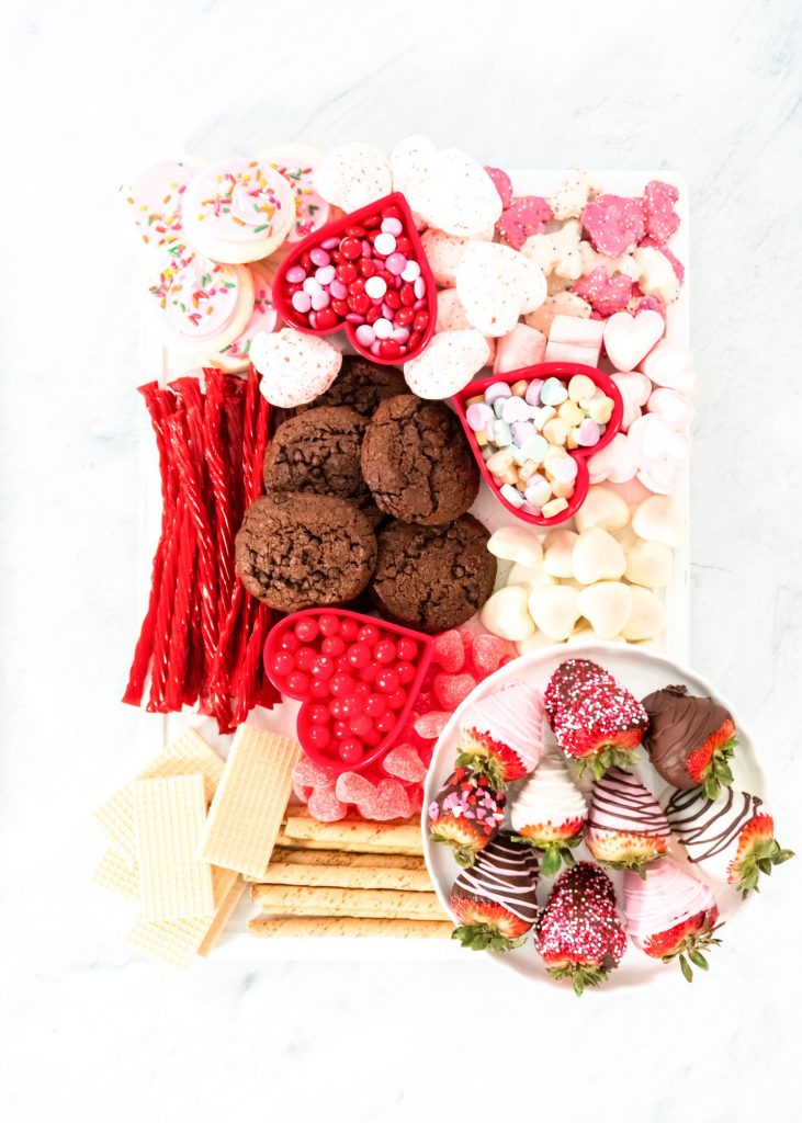 valentines day charcuterie board with cookies, candies, and brownies