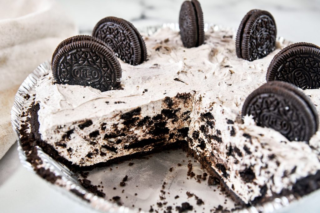 vegan Oreo cheesecake cut into slices so you can see the inside