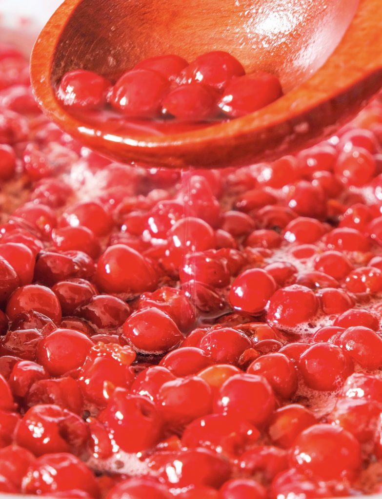 close up of a bunch of cherries in a bowl