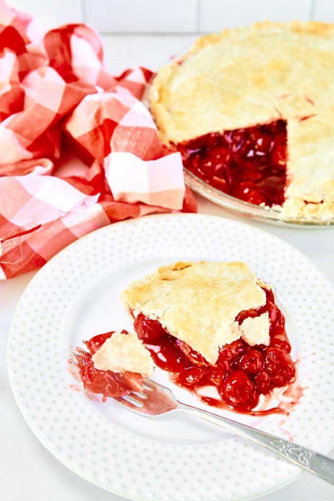 messy fork taking a bite out of vegan cherry pie slice