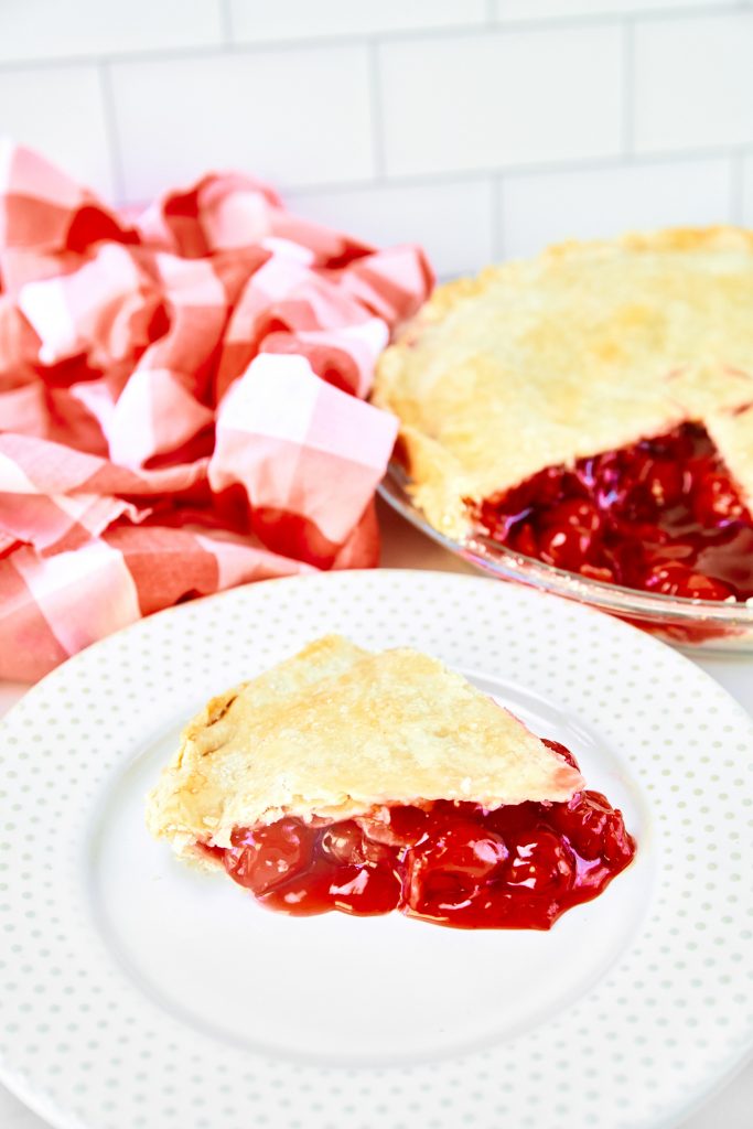 side view of a slice of vegan cherry pie on a plate