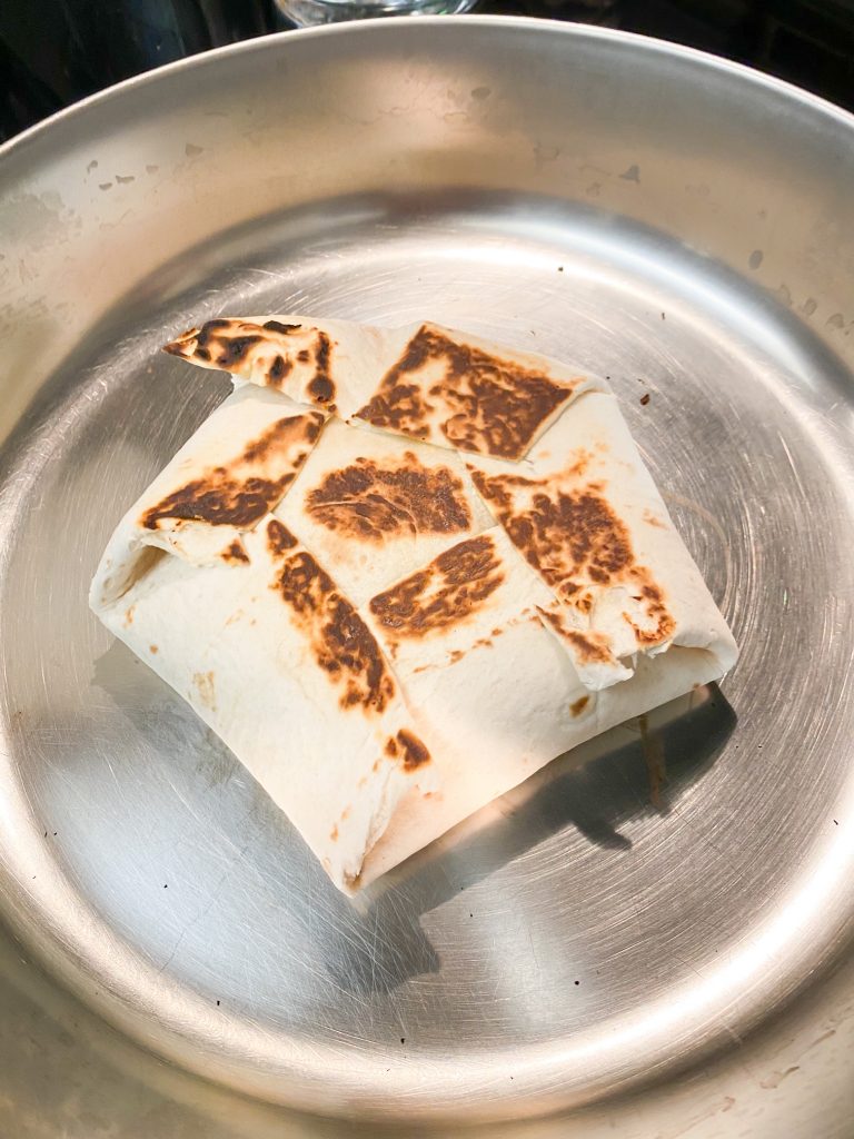fried vegan crunchwrap supreme on a frying pan