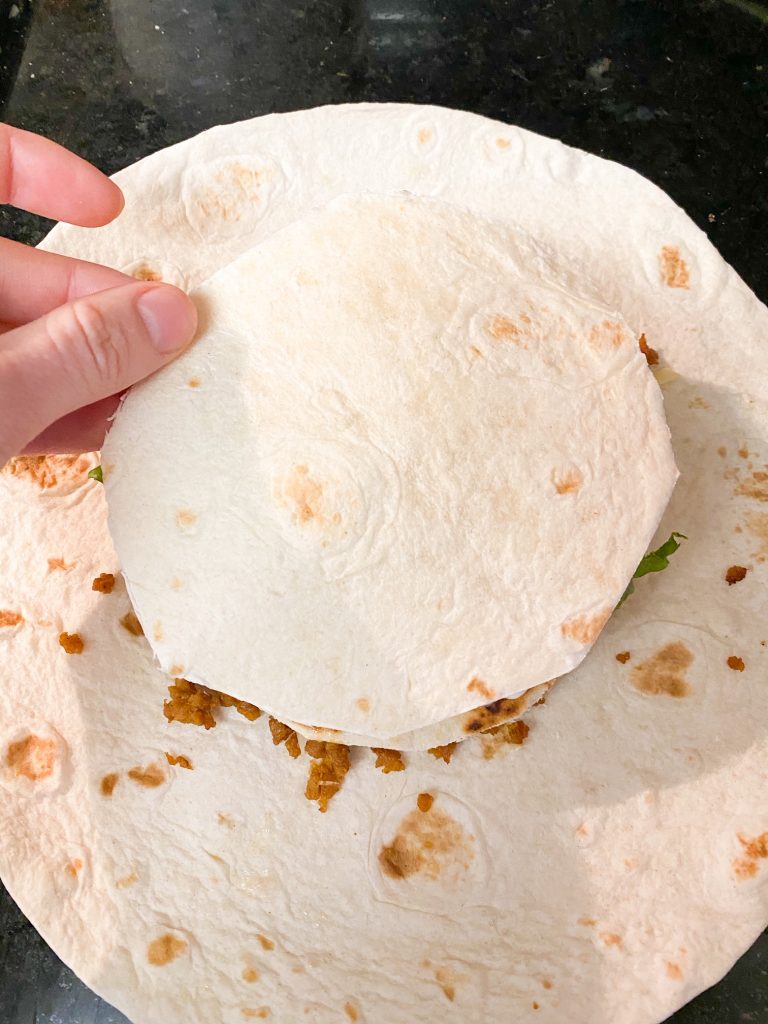 flour tortilla topping other flour tortillas to make a vegan crunchwrap supreme