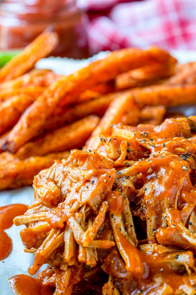 vegan jackfruit pulled pork on a plate with french fries