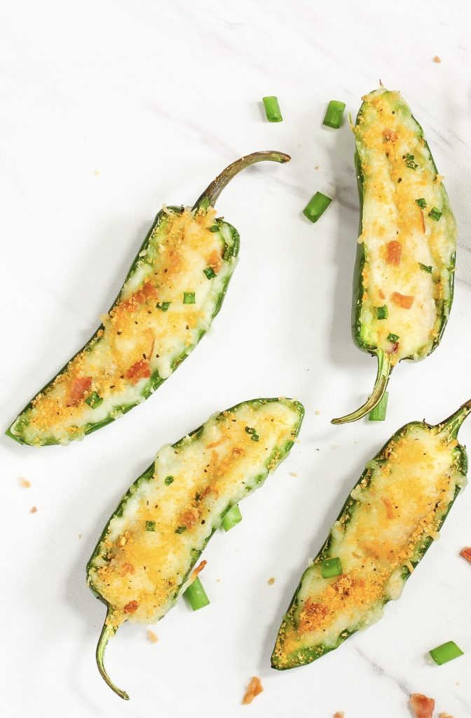 close up on vegan jalapeno poppers with green onions and vegan bacon bits