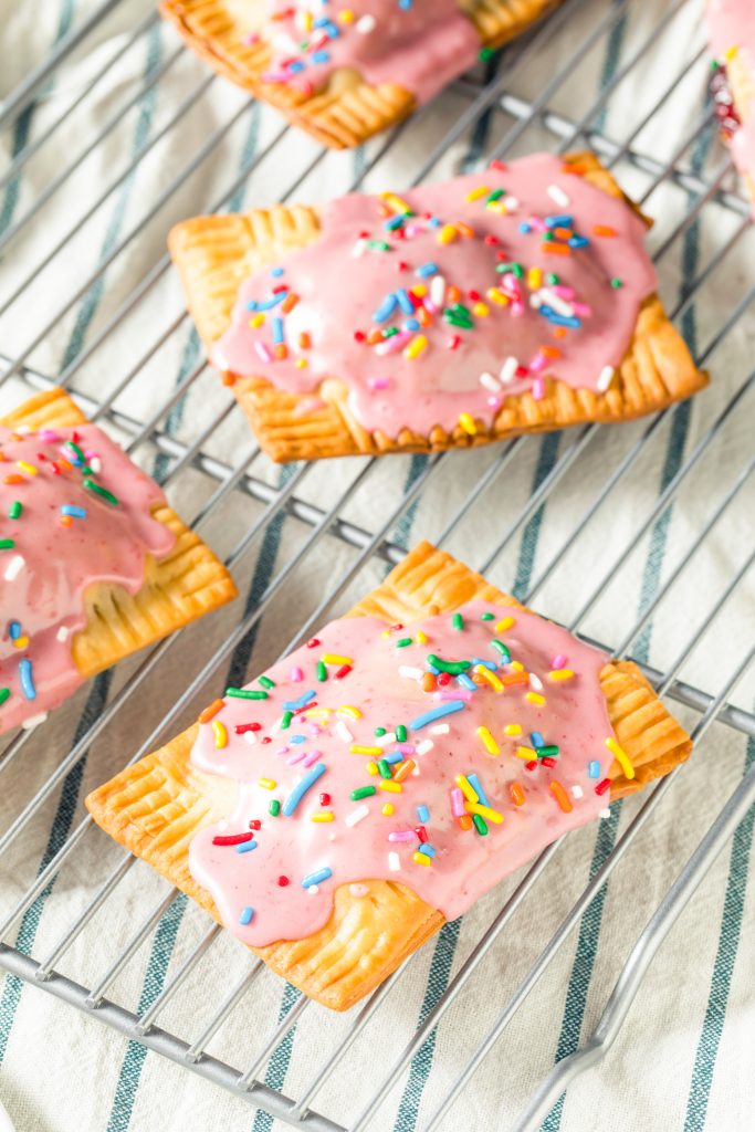 multiple pop tarts that are homemade lined up on a cooling rack
