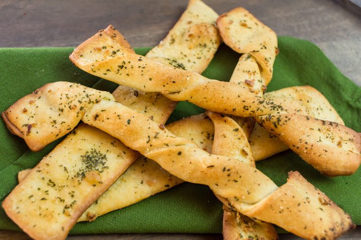 close up of vegan breadsticks on a green towel