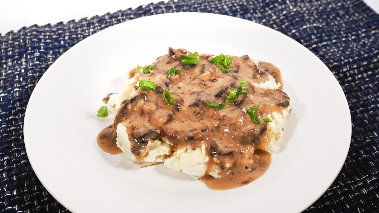 easy vegan gravy with mushrooms and brown sauce on white plate