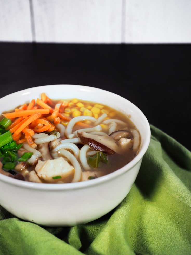 easy vegan udon noodle soup recipe on black countertop