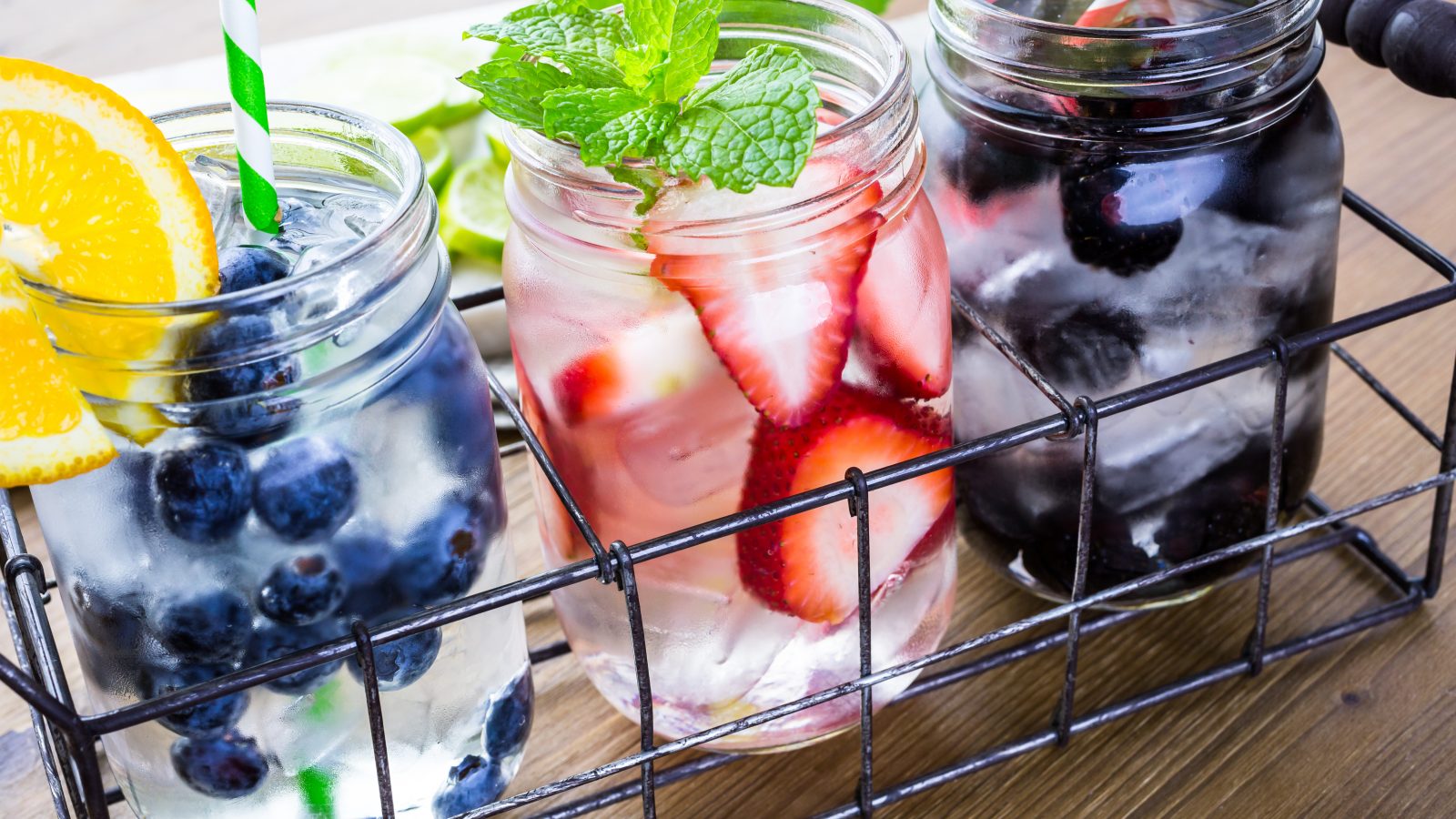 Photo of 3 fruity cocktails being served in glass mason jars.