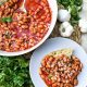 Photo of a large bowl serving arrabbiata beans one of the more spicy vegan Italian recipes.