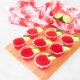 strawberry margarita vegan jello shots on tray with limes