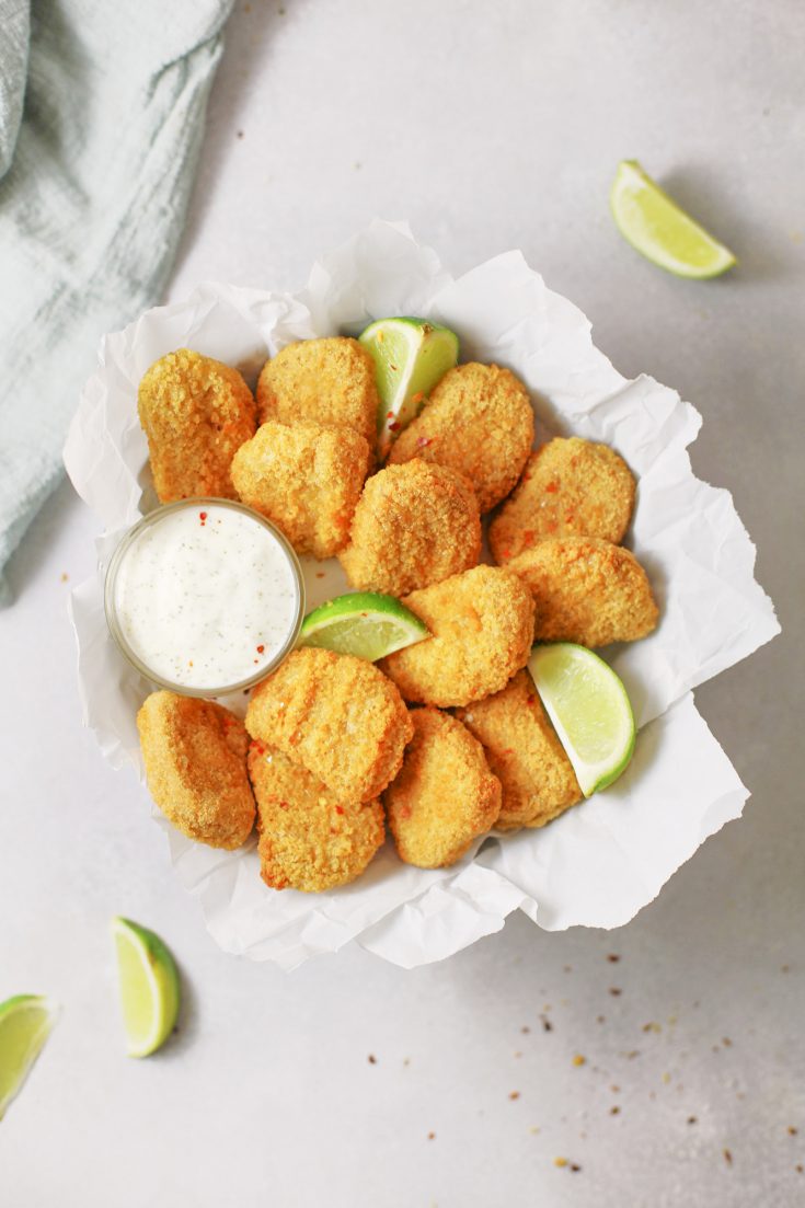 crispy baked vegan tofu nuggets in bowl with dressing