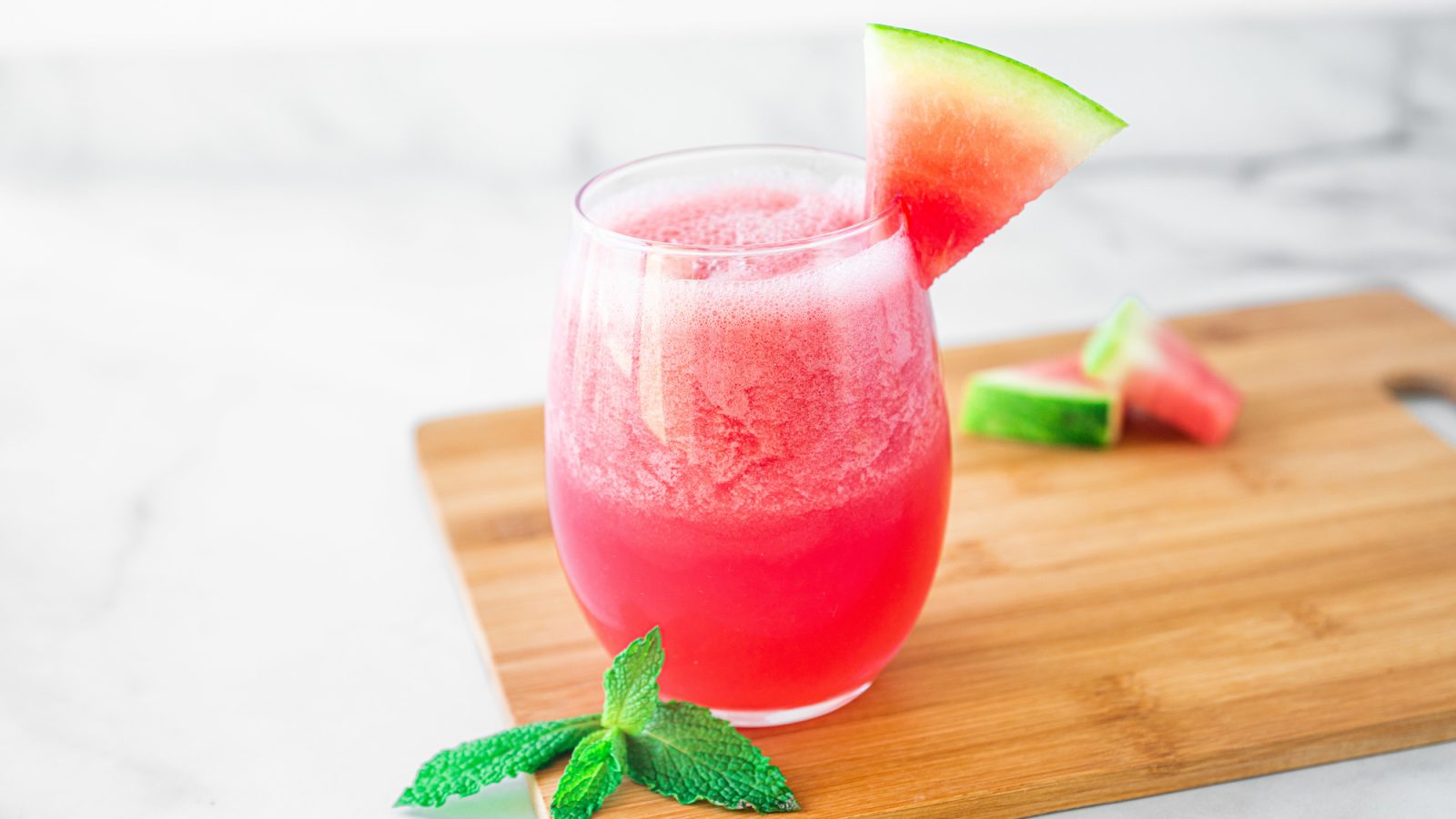 watermelon smoothie recipe on a cutting board with chopped watermelon