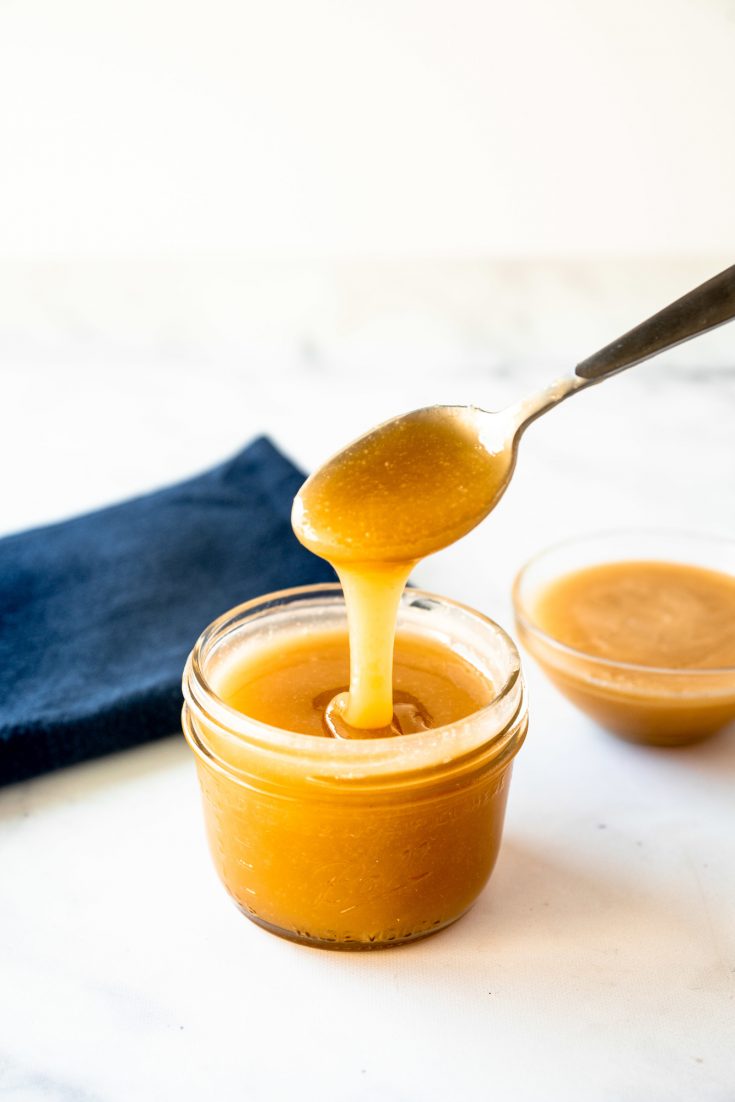 vegan caramel sauce dripping from spoon