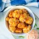 vegan crispy baked cauliflower in a bowl with dipping sauce