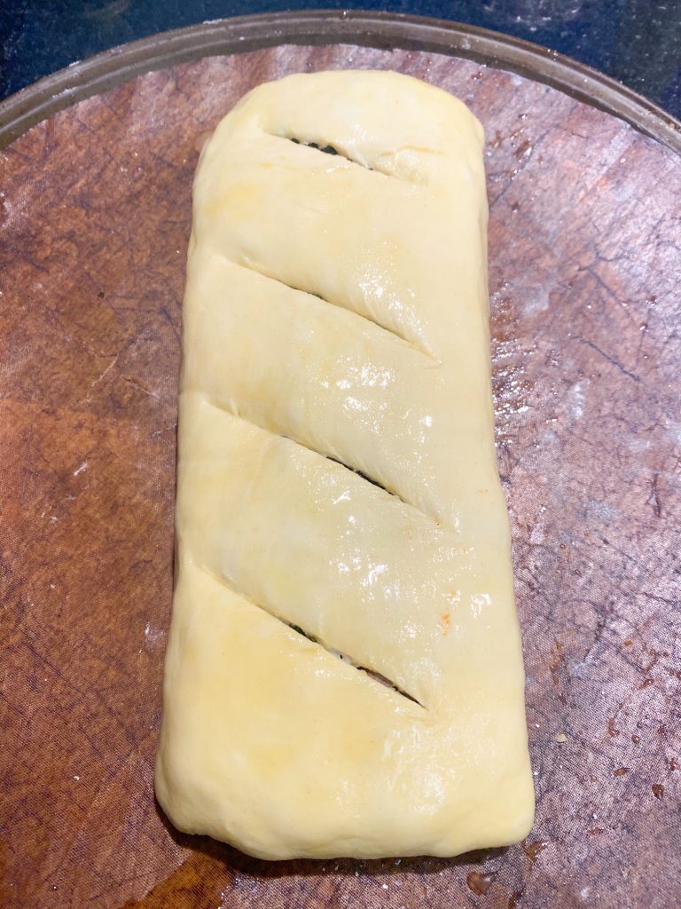 Top of folded uncooked vegan Wellington with cut slits on top.