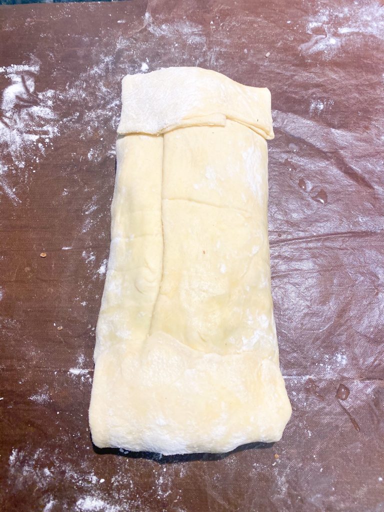 Puff pastry folded over the Wellington mixture.
