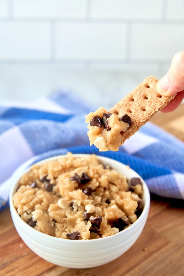 vegan cookie dough being scooped out with a graham cracker