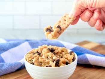 vegan cookie dough getting eaten by dipping a graham cracker into a bowl