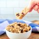 vegan cookie dough getting eaten by dipping a graham cracker into a bowl