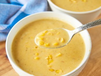 vegan corn chowder being scooped up with spoon