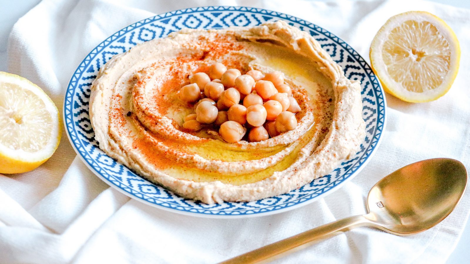 plate of vegan hummus with serving spoon