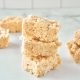 vegan rice krispie treats stacked on a white counter