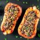 two vegan stuffed butternut squashes with parsley