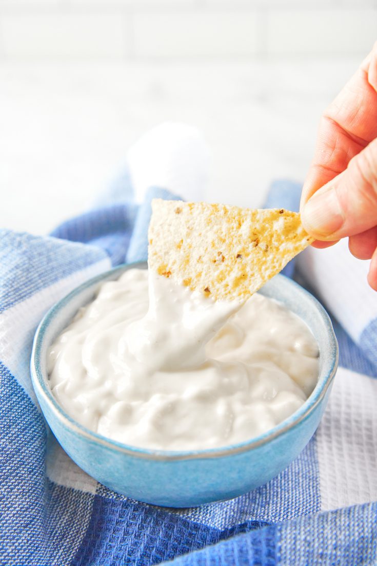 chip scooping up a bit of vegan sour cream