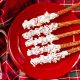 christmas pretzel rods dipped in white chocolate and topped with peppermint