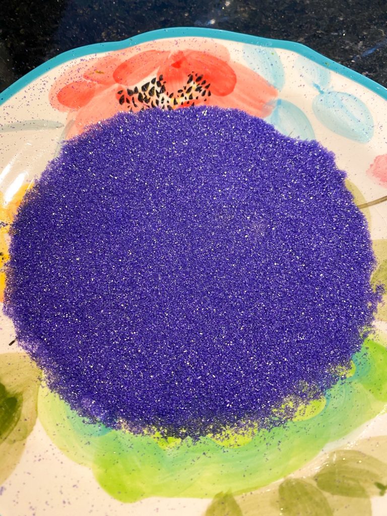 Plate of sparkling, bright purple sanding sugar.