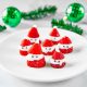 santa strawberries on plate with green ornaments in the background