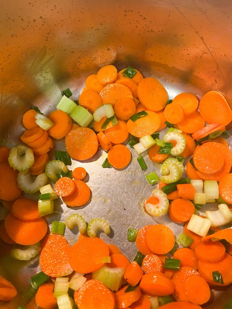Cut carrots and celery in a pot