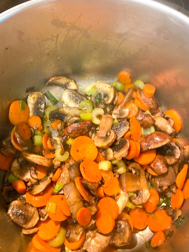 Cut carrots, celery, and mushrooms in a pot.